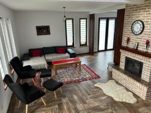 a living room with a couch and a fireplace at Cacica Holiday in Cacica