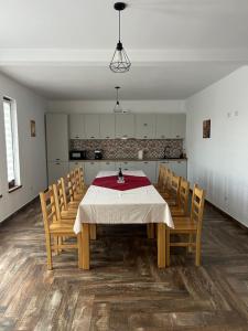 a dining room with a table and chairs at Cacica Holiday in Cacica