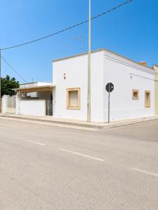 a white building on the side of a street at Villetta Natalia 2 in Torre Colimena