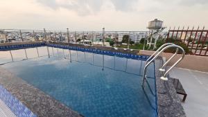 a swimming pool on the roof of a building at Hotel Silver Oak in Dehradun