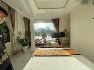 a bedroom with a bed and a view of a living room at Anh Duong in Lục Yên