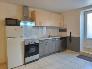 a kitchen with a white refrigerator and a sink at NEW! Appartement PrixMalin 1 à 7 personnes in Champagnole