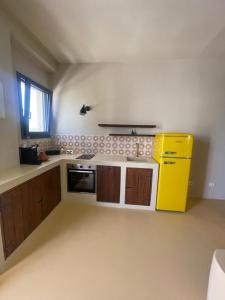 a kitchen with a yellow stove and a yellow refrigerator at Riad Gilda in Torre Canne +14 photos
