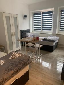 a room with a bed and a table and a couch at Unterkunft Mara in Oberhausen
