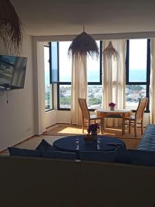 a living room with a couch and a table at Appartement LE SABLE Uniquement les familles in Oualidia