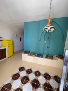 a room with a blue wall and a checkered floor at Riad Gilda in Torre Canne