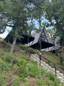 a building on top of a hill with trees at Serenity in Eşelniţa