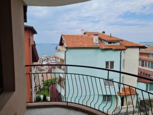 a balcony with a view of a building at Алми Almi in Sveti Vlas