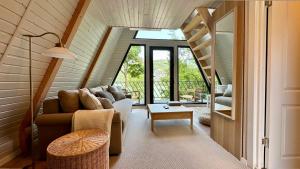 a living room with a couch and a staircase at Serenity in Eşelniţa