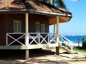 a small house with a porch on the beach at Coconut Grove Beach Cabanas in Hungama