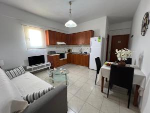 a living room with a couch and a table at Heaven Studios & Apartments in Stalís