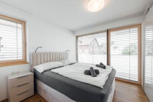 a bedroom with a bed with two teddy bears on it at Bodensee Bergblick Nest by Stadtlandnest in Lochau