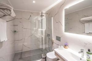 a bathroom with a shower and a toilet and a sink at Riversea Suite & Hotel in Lara +32 photos
