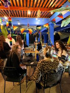 a group of people sitting at tables in a restaurant at Raymi House Hostel in Arica