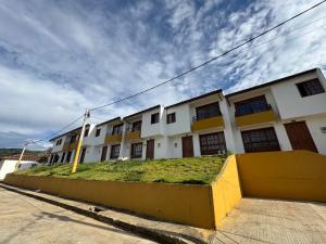 a building with a grassy area in front of it at Sofi House Zap in Zapatoca