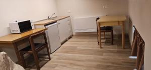 a small kitchen with a desk and a table and a sink at Casa Delia in Piazzano