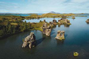 an aerial view of some rocks in the water at Vogafjós Farm Resort in Myvatn