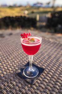 a drink in a glass sitting on a table at Vogafjós Farm Resort in Myvatn