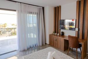 a room with a desk and a large window at Suya Boutique Hotel in Kyrenia