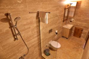 a bathroom with a shower with a toilet and a sink at Süleyman Cappadocia - Hot Air Balloon View in Göreme +46 photos
