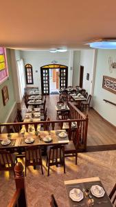a dining room with many tables and chairs at Pousada Luar da Serra in Valença