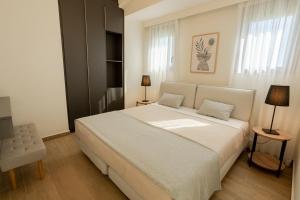 a bedroom with a large white bed with two pillows at Forestbreeze in Metóchion +82 photos
