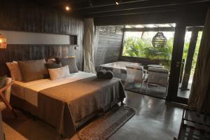 a bedroom with a large bed and a bathroom at Vila Torém in Icaraí +116 photos