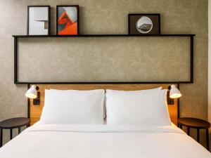 a bedroom with a bed with two tables and a headboard at ibis Tilburg in Tilburg +72 photos