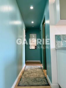 a hallway with blue walls and a rug at GC - Les Oyats in Wissant +22 photos