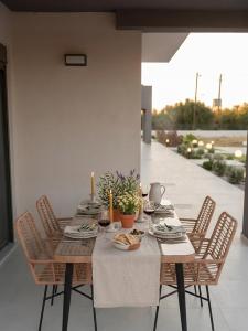 a dining room table with chairs and a table with food at Forestbreeze in Metóchion