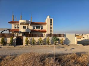 a house in the desert with trees in front of it at Bissan Condimenium in Amman