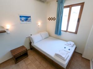 a small room with a bed and a window at The Windmill in Ios Chora