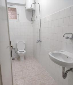 a bathroom with a toilet and a sink at NJ Teachers Hotel in Luxor