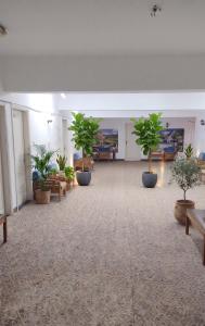 a large room with potted plants and benches at NJ Teachers Hotel in Luxor