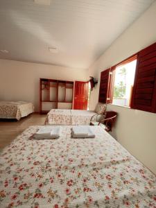 a bedroom with two beds and a window at Pousada Janelas do Mar in Flecheiras +185 photos