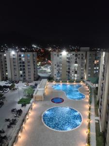 a view of two swimming pools on a balcony of a building at Via Tayrona in Santa Marta