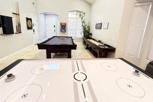 a ping pong table in a room with a pool table at Summerlin Private Buddha Estate Resort - Pool, Spa, Sauna, Game Room, Basket ball, Mini golf, Gym in Las Vegas