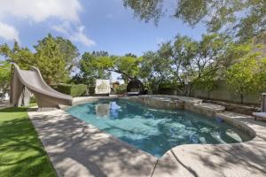 a swimming pool with a slide in a yard at Summerlin Private Buddha Estate Resort - Pool, Spa, Sauna, Game Room, Basket ball, Mini golf, Gym in Las Vegas
