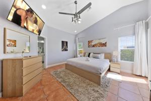 a bedroom with a bed and a ceiling fan at Summerlin Private Buddha Estate Resort - Pool, Spa, Sauna, Game Room, Basket ball, Mini golf, Gym in Las Vegas +64 photos