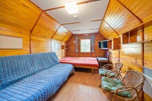 a living room with a blue couch in a room at Chatka Kačka in Jedovnice