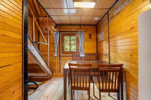 a dining room with a table and chairs in a cabin at Chatka Kačka in Jedovnice