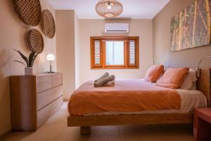 a bedroom with a bed and a dresser and a window at Luxury Ocean View Apartment, Private Beach, Infinity Pool, near Jan Thiel C4 in Willemstad +61 photos