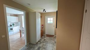 a room with a hallway with a kitchen and a door at Gårdsjö 5 in Gårdsjö