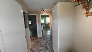 a hallway with a room with a door and a hallway at Gårdsjö 5 in Gårdsjö