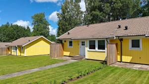 a yellow house with a yard at Gårdsjö 5 in Gårdsjö +18 photos