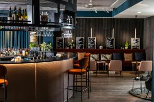 a bar in a restaurant with chairs and tables at Motel One Copenhagen in Copenhagen