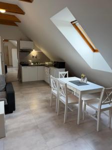 a kitchen and dining room with a table and chairs at Apartmány Polevsko in Polevsko