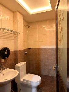 a bathroom with a toilet and a sink at New century inn in Bintulu
