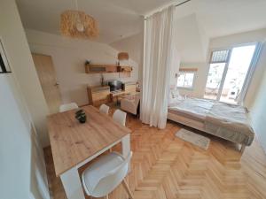 a room with a table and a bed and a desk at Queen's Apartment Ohrid in Ohrid
