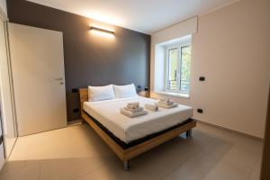 ein Schlafzimmer mit einem Bett mit weißer Bettwäsche und einem Fenster in der Unterkunft Casa Luccon in Salionze
